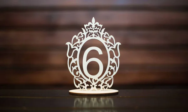 Decorative number six carved in wood