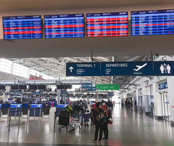 Prague, Czechia - March 17, 2020, airport hall and cancellation of flights departing due to coronavirus, signs on the plates: cancellation of flights and departures, closed airports