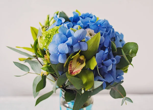 romantic bouquet with blue hydrangea and rose