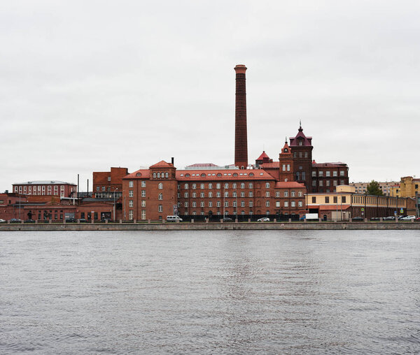 Saint Petersburg, Russia - July 17, 2020, industrial brick building on the river bank