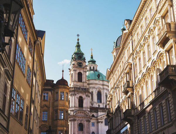 Prague, Czech Republic - August 1, 2020, Lively Malaya Strana street overlooking the Church of Saint Nicholas