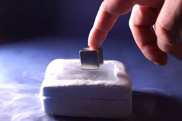 Levitación del cubo en un cojín magnético. Propiedades del meta congelado — Foto de Stock