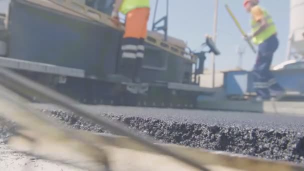 Spridnings asfalt med skyfflar och pinnar — Stockvideo