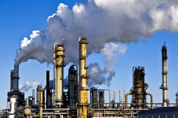 Smoke from the pipes of an oil refinery