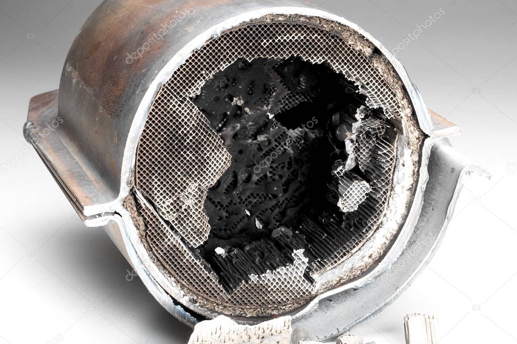 Cut muffler car with a platinum catalyst. Muffler of the exhaust system of the car on a white background.
