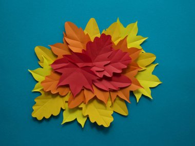 Kağıt sonbahar yaprakları bir daire içinde. Kırmızı, sarı ve turuncu yaprak. Kayıt için bir yer. Mavi arka plan.