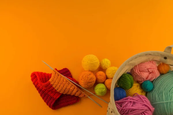 在橙色背景下由羊毛制成的彩虹帽 复制空间 从上面查看 带绒球的条纹针织保暖帽 — 图库照片