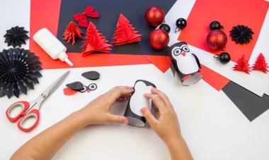Çocuk ana sınıfı el yapımı kağıt penguen. Bir çocuğun eli. Bebek Handmade.Creativity.