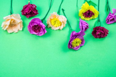 Kapkacak ve aletleri krep kağıt çiçekler üzerinde yeşil arka plan yapmak için. Cosmos çiçek buketi