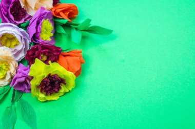 Kapkacak ve aletleri krep kağıt çiçekler üzerinde yeşil arka plan yapmak için. Cosmos çiçek buketi