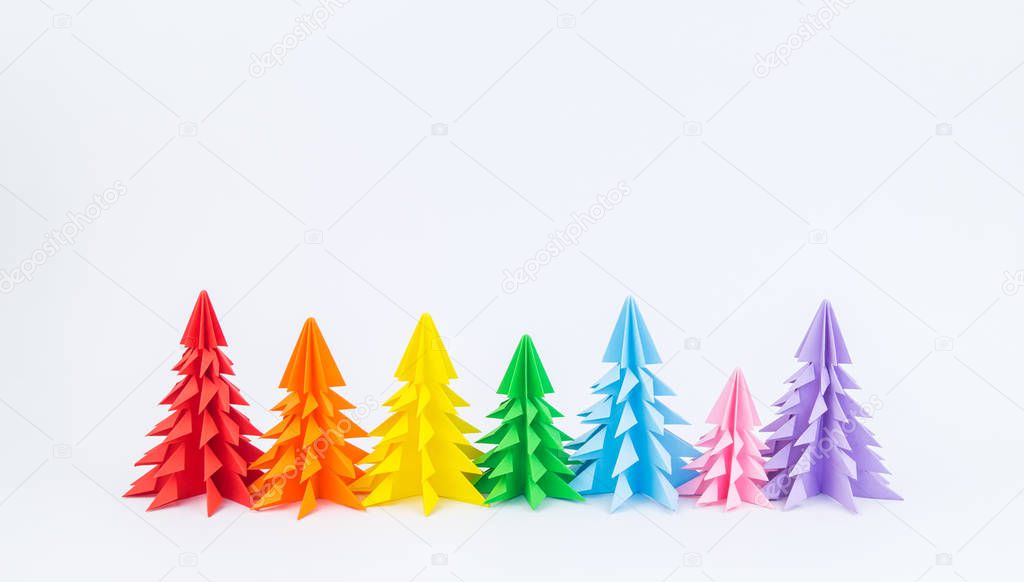 Multicolored paper Christmas tree on a white background. new Year Children's holiday. Rainbow origami. Copy spase