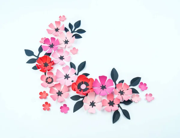 Flower and leaf of pink and black color made of paper. Handwork, favorite hobby. White background.