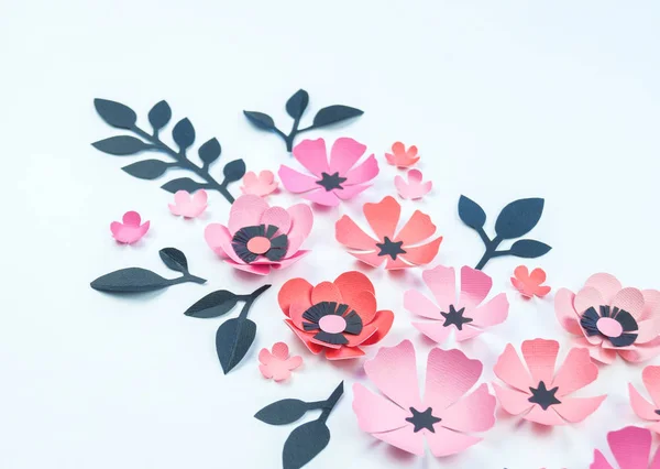 Flower and leaf of pink and black color made of paper. Handwork, favorite hobby. White background.