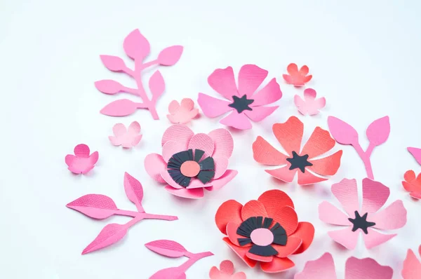 Flower and leaf of pink and black color made of paper. Handwork, favorite hobby. White background.