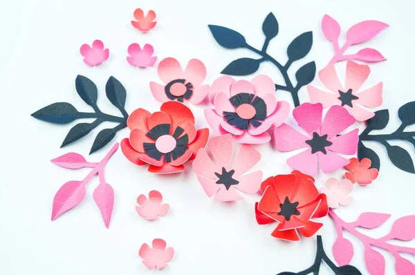 Flower and leaf of pink and black color made of paper. Handwork, favorite hobby. White background.