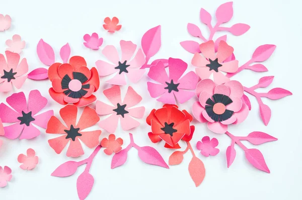 Flower and leaf of pink and black color made of paper. Handwork, favorite hobby. White background.