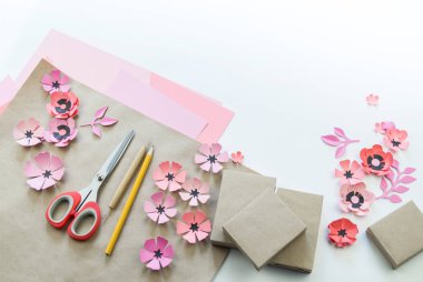 Kurdela ve çiçekler ile şenlikli bir kutu ambalaj. Çiçek kağıttan yapılmış. En sevdiği hobi. Yukarıdan görüntülemek.