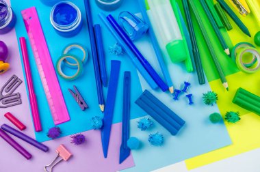 Okul aksesuarları bir gökkuşağı şeklinde yerleştirilir. Beyaz arka plan. Geri okul öğrenci için çok mutluyum. Sanat ve el sanatları çocuklar için. Gökkuşağı renkleri, alfabe harfler ve sayılar öğrenme çocuk.