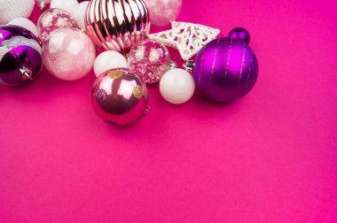 Yumuşak pembe ve mor baubles pembe bir arka plan üzerinde. Noel ruh. Festival dekor. Payetler ve bir parti için glitter.