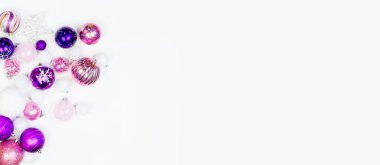 Yumuşak pembe ve mor baubles beyaz zemin üzerinde. Noel ruh. Festival dekor. Payetler ve bir parti için glitter.