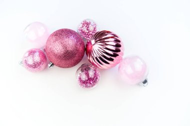 Beyaz bir arka plan üzerinde yumuşak pembe baubles. Noel ruh. Festival dekor. Payetler ve bir parti için glitter.