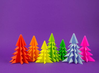Noel ağacı gökkuşağı zanaat kağıttan yapılmış. El sanatları. Menekşe arka plan. Orman origami