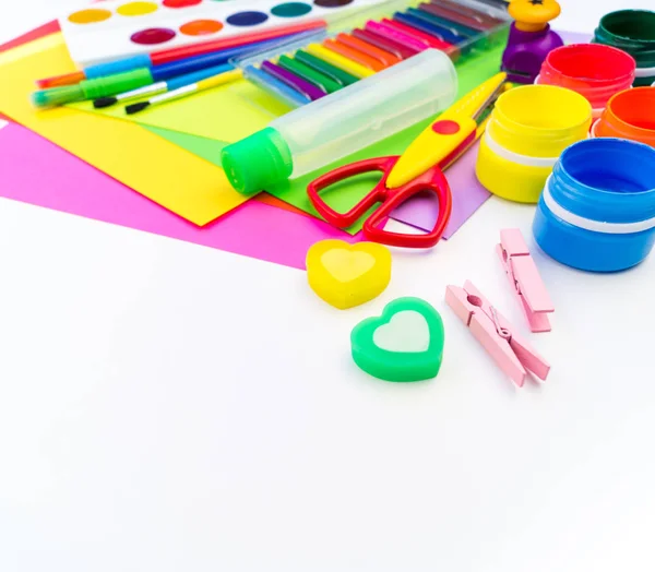 School accessories are laid out in the form of a rainbow. white background. Happy back to school student. Art and crafts for kids. Child learning rainbow colors, alphabet letters and numbers.