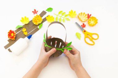Çocuk kağıttan bir sepet yapıştırıyor. Tatil Paskalya.