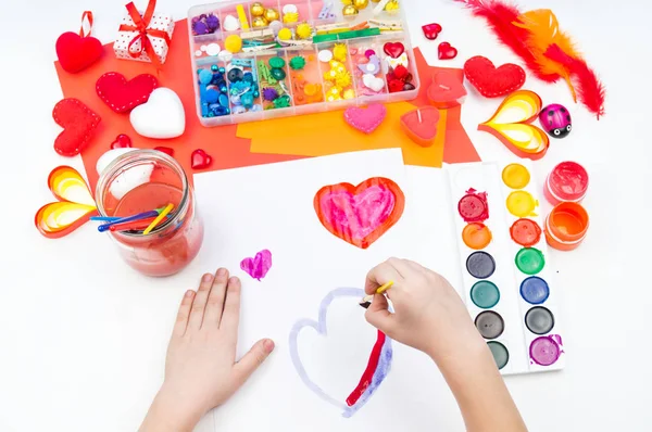 Child paints watercolors. Word love written on paper. — Stock Photo, Image