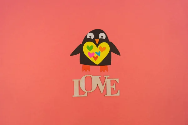Woord liefde voor hout en papieren pinguïn. Koraalachtergrond. — Stockfoto
