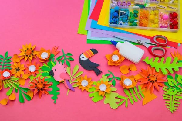 Creative setting. The process of cutting leaves and flowers from paper. Tropics exotic jungle.