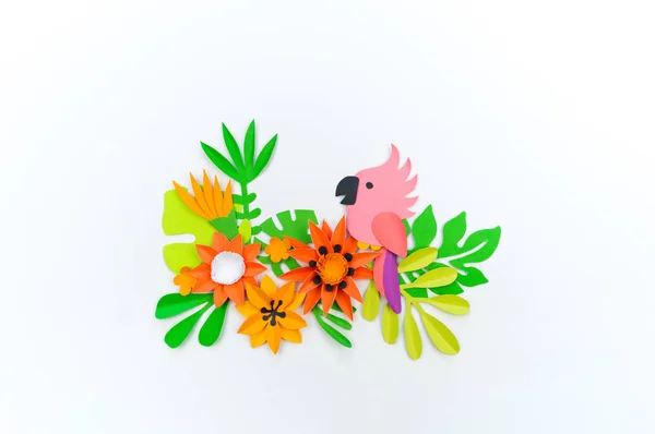 Decorative Arrangement of tropical leaves and flowers. Pink paper parrot bird — Stock Photo, Image
