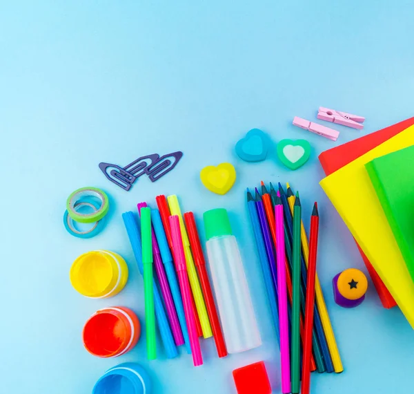 Stationery for study at school lies on blue. Back to school. Rainbow color