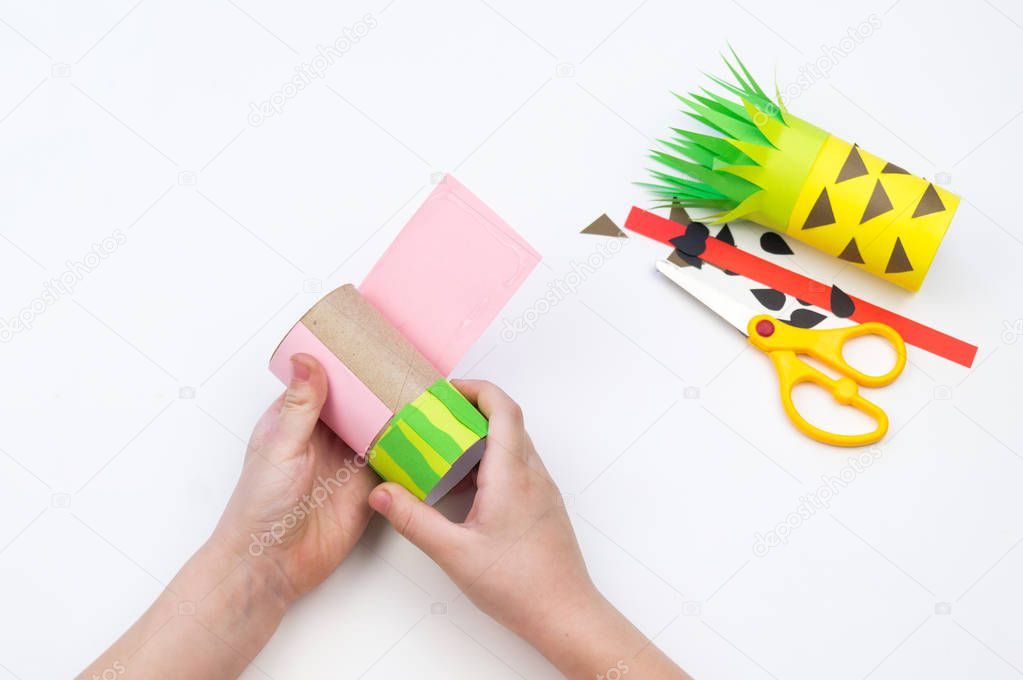 Child does the handicraft. Fruit paper. Pineapple and Watermelon summer.