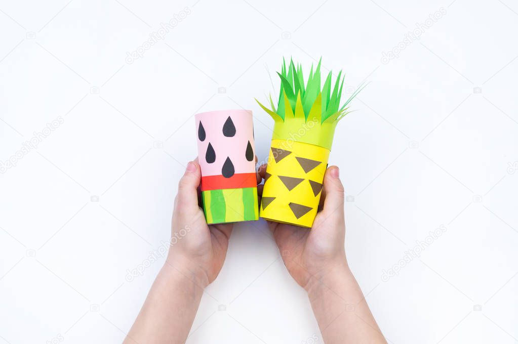 Child does the handicraft. Fruit paper. Pineapple and Watermelon summer.