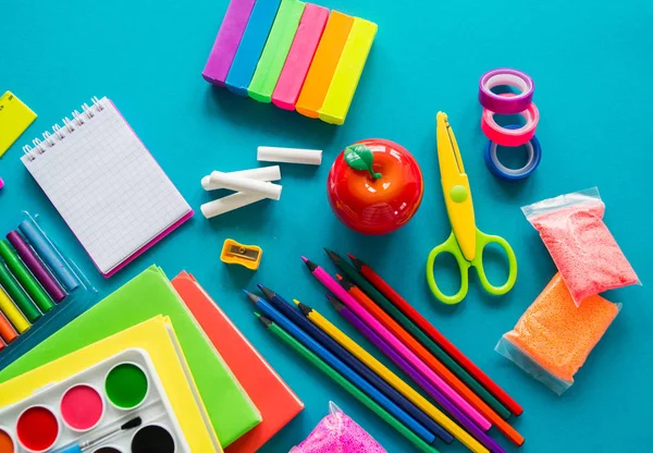 Stationery for study at school lies on blue. Back to school. Rainbow color