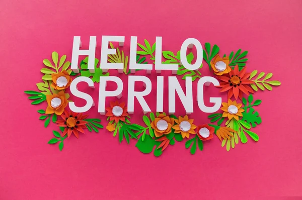 Hello Spring May hand lettering card. Spring tulip narcissus, plumeria paper craft flowers on dark pink background.