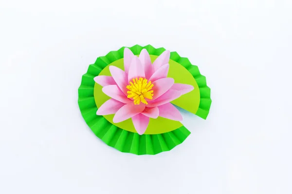 Waterlily flower made of paper. white background. Origami hobby. Gentle petal.