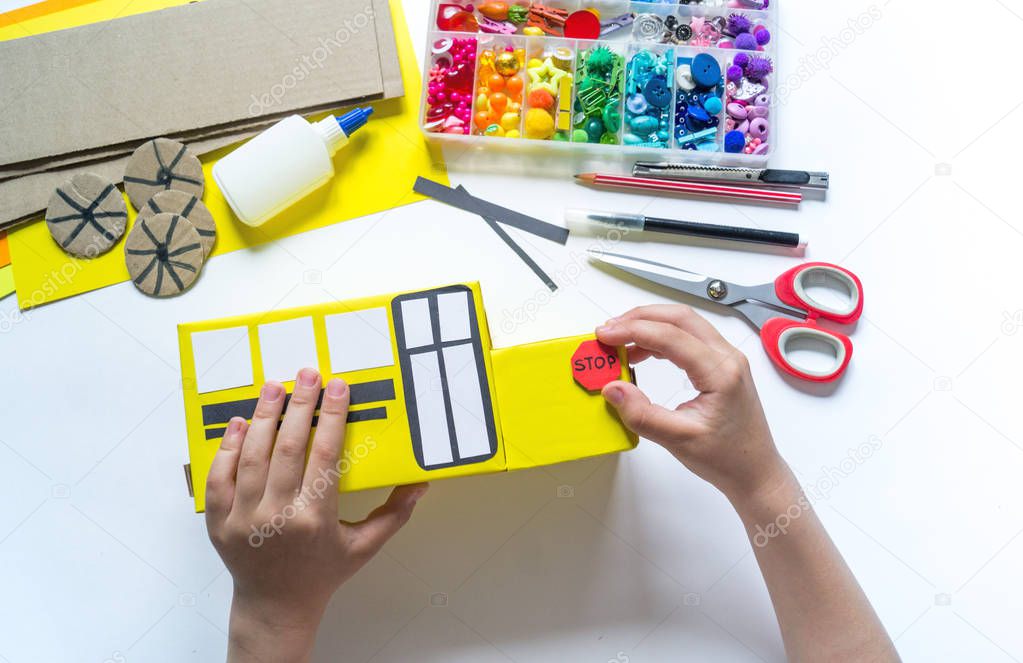 School bus made of cardboard. DIY children's pencil case for stationery paper craft.