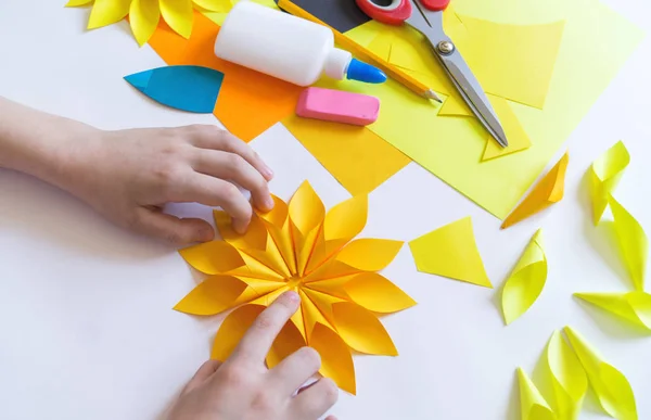 Руки дитини роблять непарний квітковий папір з соняшнику. Жовті рослини влітку. Творчий процес . — стокове фото