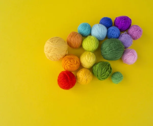 Ball for knit rainbow color a yellow background. — Stock Photo, Image