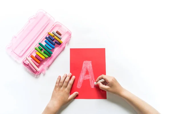 Children\'s hands write the letter A chalk. White background. Write ABC. Office Back to School