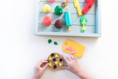 Montessori maddesi plastiktir. Şef eğitimi oyunu. Tahta tepside çocuk elleri. Beyaz arkaplan