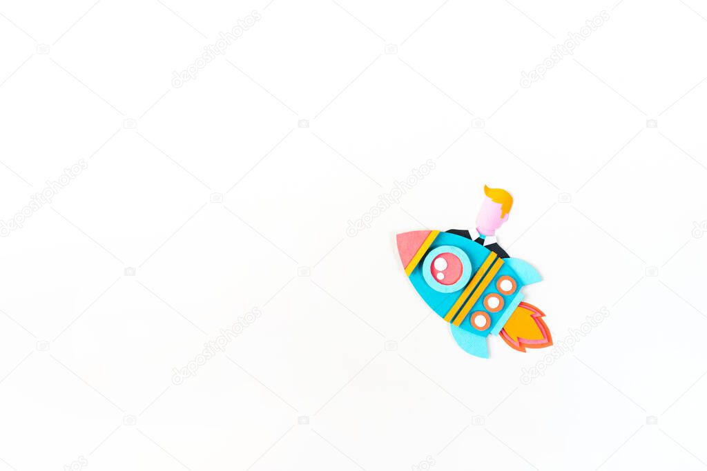 Rocket craft paper. Business startup concept. Man flies White background Copy space
