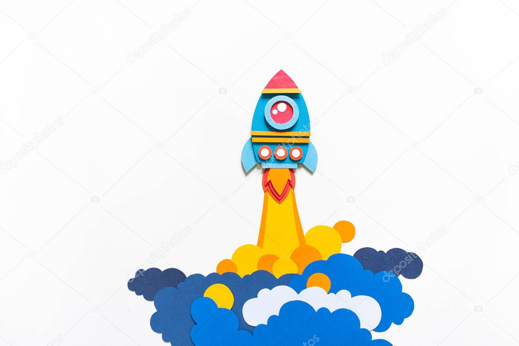 Rocket takes off paper craft. Back to school. Copy space. White background. Business concept
