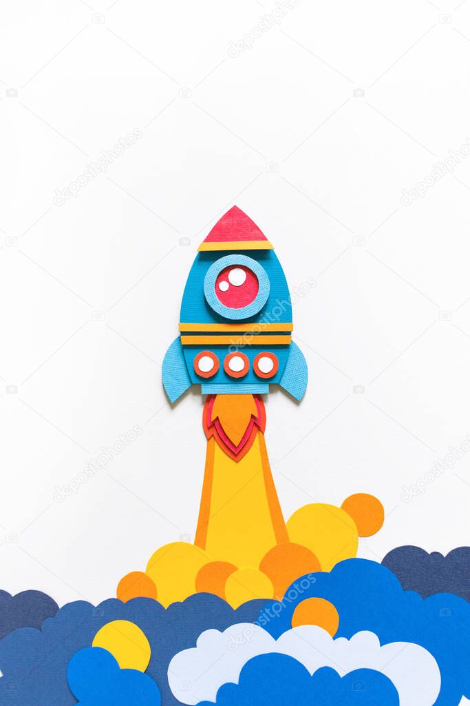 Rocket takes off paper craft. Back to school. Copy space. White background. Business concept