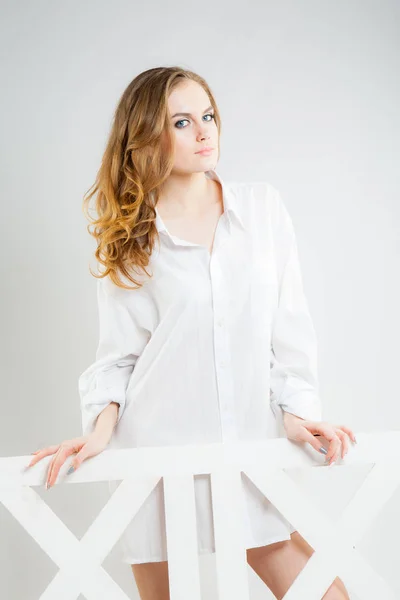 Young beautiful woman in a white men's shirt — Stock Photo, Image