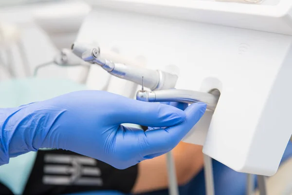 hand of a dentist taking modern tools for use