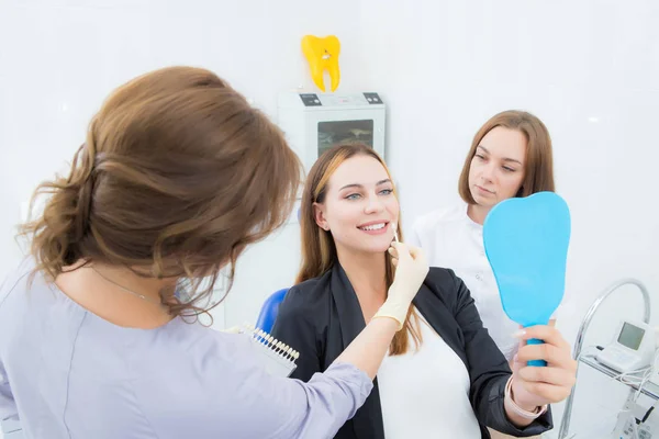 Vrouw kiest tand kleur, kroon, fineer — Stockfoto