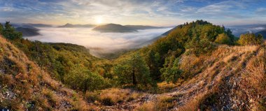 Autumn sunrise above mist and forest landscape, Slovakia, Nosice clipart